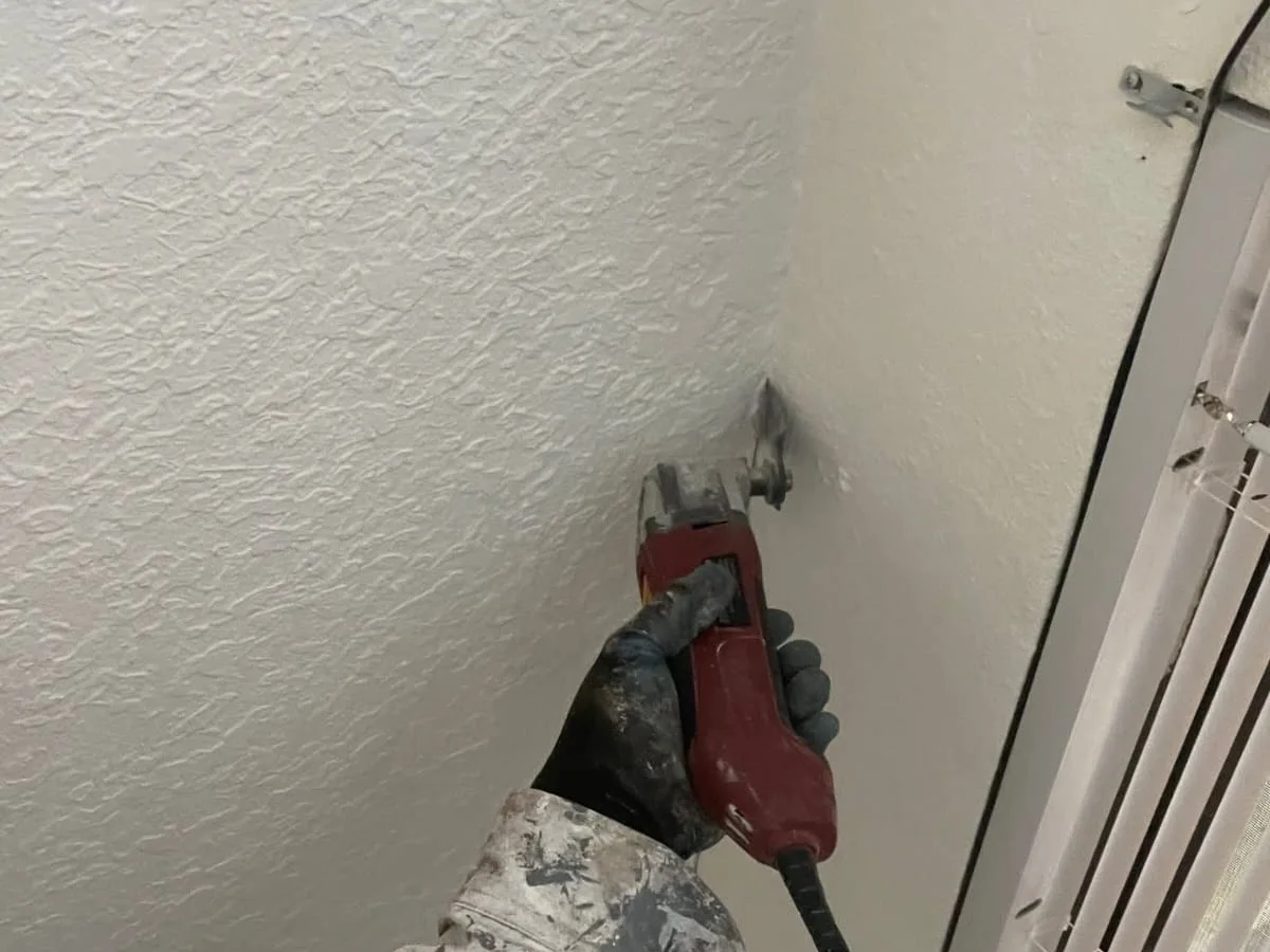 Sanding a repaired ceiling before paint