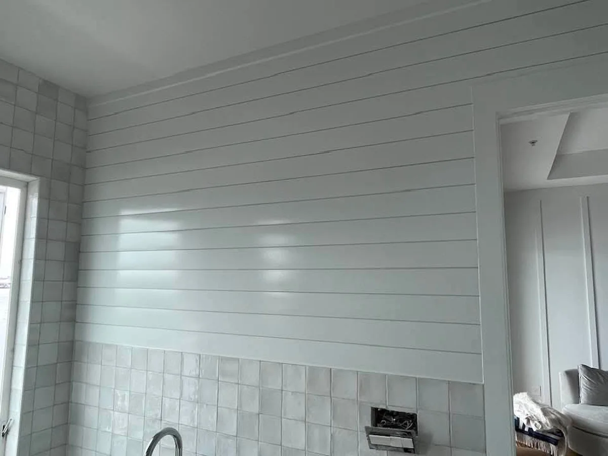 White shiplap wall and tile in a kitchen