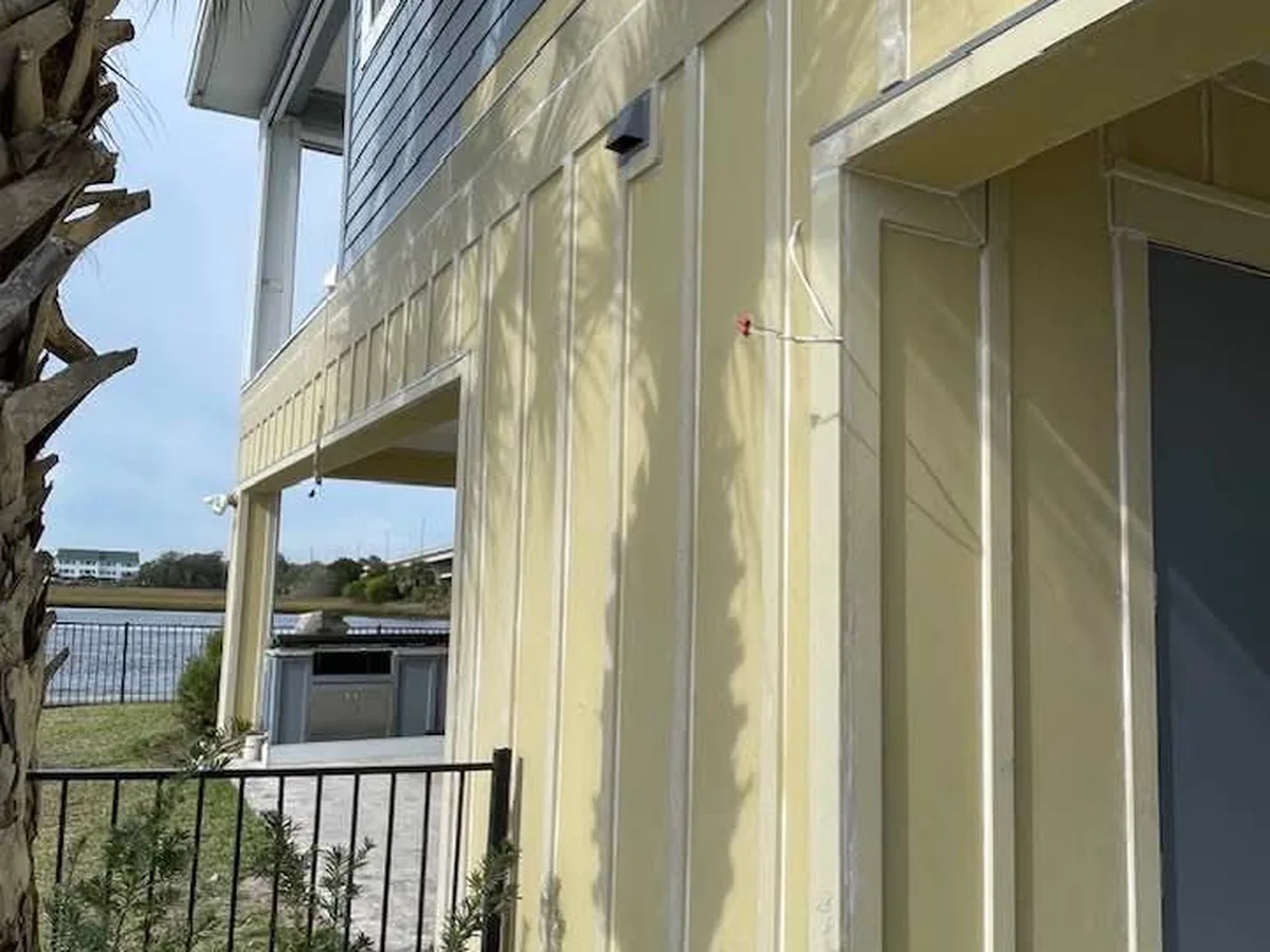 Exterior siding masked and painted on a waterfront home